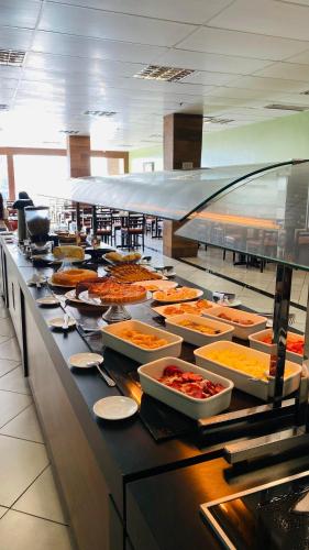 a buffet line with many different types of food at Hotel Atlantico Macaé By Inn House in Macaé