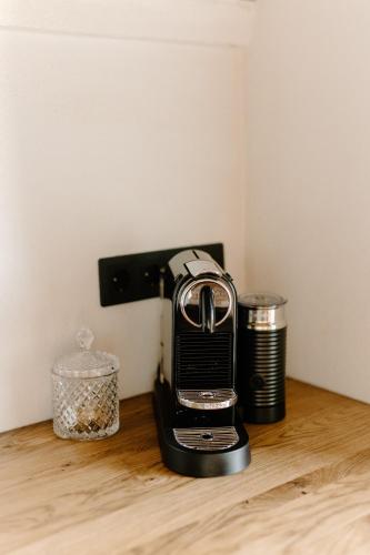 a black toaster sitting on top of a wooden table at Paulīnes in Alsunga