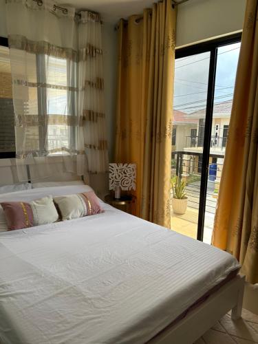 a bedroom with a bed and a large window at Casa Almera in Totolan