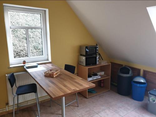 a table and chairs in a room with a window at Fewo David und Marion oben, nahe der Nordsee und dem Weser Radweg in Golzwarderwurp