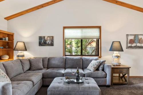 a living room with a couch and a table at Cozy 3BR Dog-Friendly Cabin- Level 2 EV Chgr in Lake Arrowhead