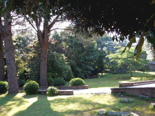 a park with trees and grass and bushes at Tenuta Montelaura in Forino