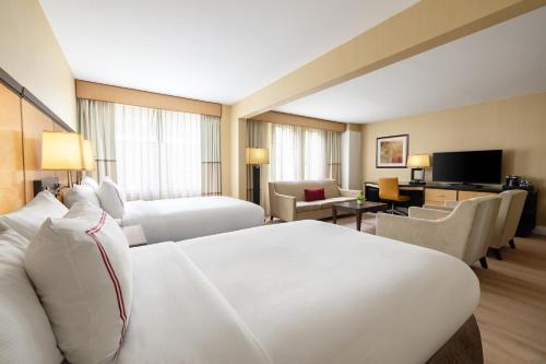 a hotel room with a bed and a living room at Sleepy Hollow Hotel in Tarrytown