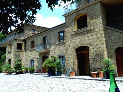 a building with potted plants in front of it at Tenuta Montelaura in Forino