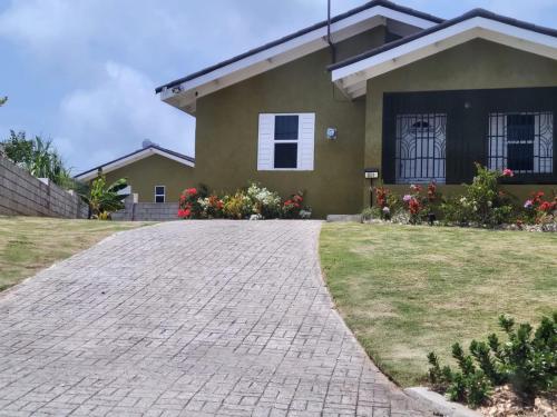 a house with a brick driveway in front of it at Ocean View Get Away in Falmouth
