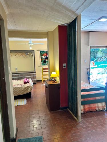 a room with two beds and a desk with a lamp at oasis en la ciudad in Eldorado