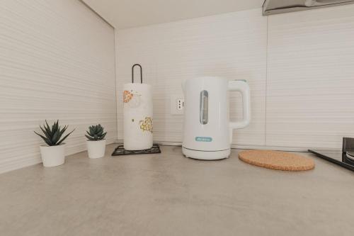 two white appliances sitting on the floor in a room at Bedda Apartment in Cefalù