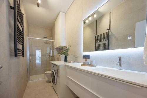 a bathroom with a sink and a toilet and a mirror at Apartman Ivan in Posedarje