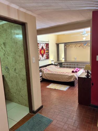 a bedroom with a bed and a mirror in a room at oasis en la ciudad in Eldorado