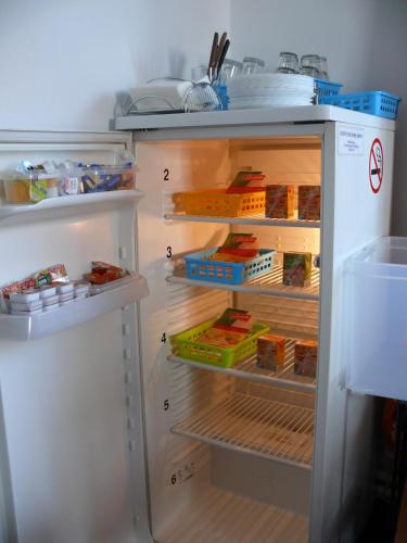 a refrigerator with its door open with food inside at Penzion Dana Troja in Prague