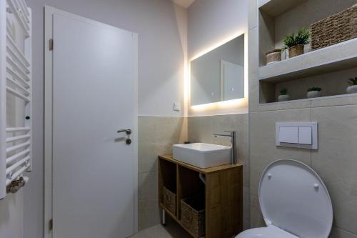 a bathroom with a white toilet and a sink at Casa Cordis in Korduševci