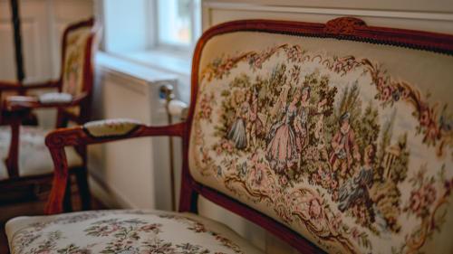 a chair with a painting on the back of it at Svaneholm Hotel in Svanskog