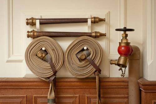 a wall with two coils of rope and a fire hydrant at Springkell in Eaglesfield