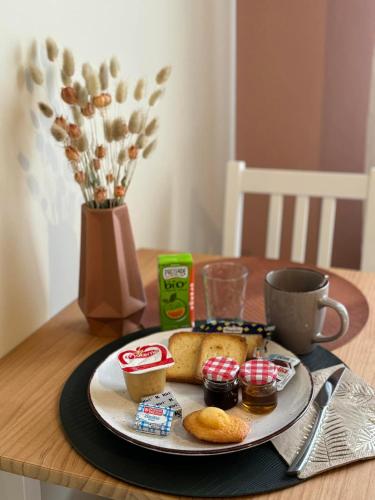 a plate of food on a table with a cup of coffee at La Maison d'Irmine in Sarralbe