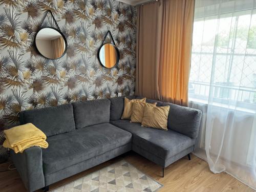 a living room with a couch and a wall at Orientarium Zoo Atlas Arena Retkinia District Parking in Łódź