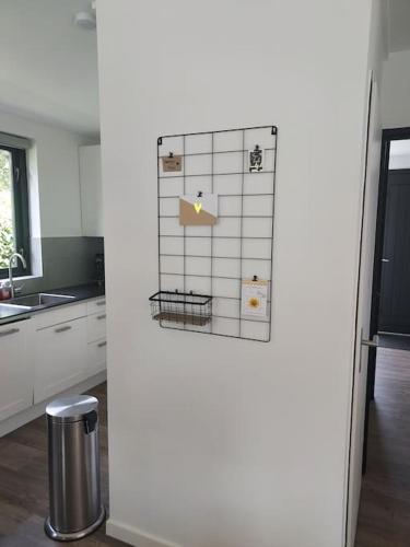 a kitchen with a refrigerator with magnets on it at Heerlijk Huys, Vakantievilla met privé tuin in Ewijk