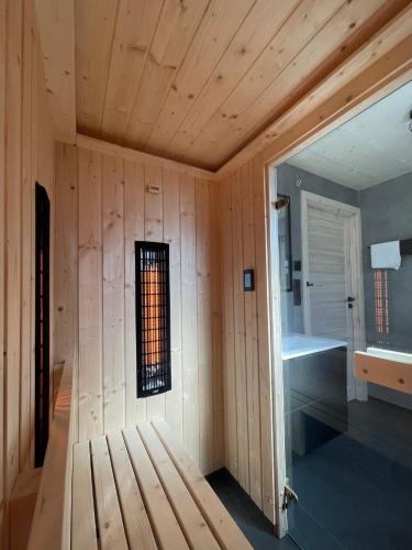 a wooden room with a bench and a window at Muchatki domki z sauną in Zagórze