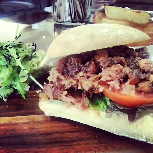 a sandwich with meat and tomato and a salad at Staindrop Hotel in Sheffield
