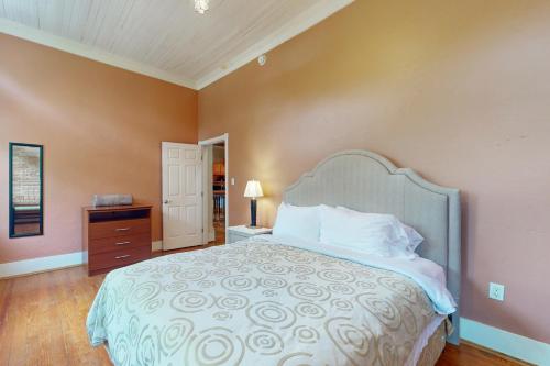 a bedroom with a large bed and a dresser and a door at Mountain Stream Haven in Whittier