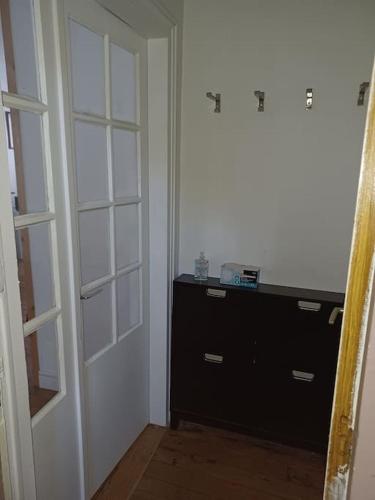 a room with a door and a dresser in a room at Le Duplex quartier cathédrale-marais in Bourges