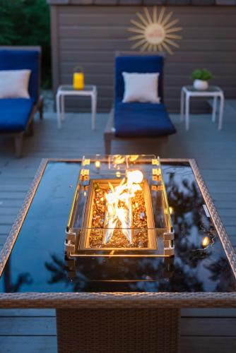 a living room with a table with a fire place at Serene POOL & Firepit in Stunning Home By Airport in San Antonio