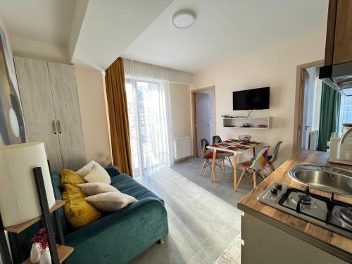 a living room with a blue couch in a kitchen at Didveli, apartment Kesane in Bakuriani