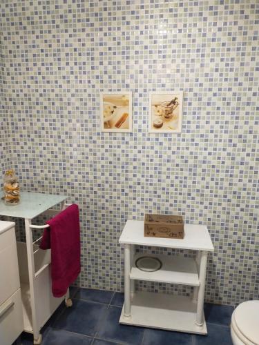 a bathroom with a white toilet and a table at Centro Ciudad Piso con Encanto in Santander