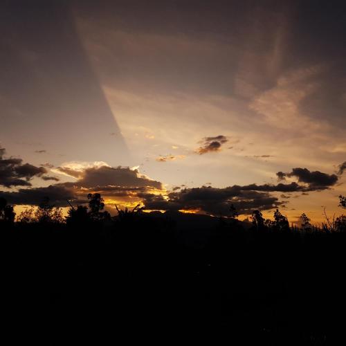 an image of a sunset with the sky at Hacienda Jimenita Wildlife Reserve in Puembo