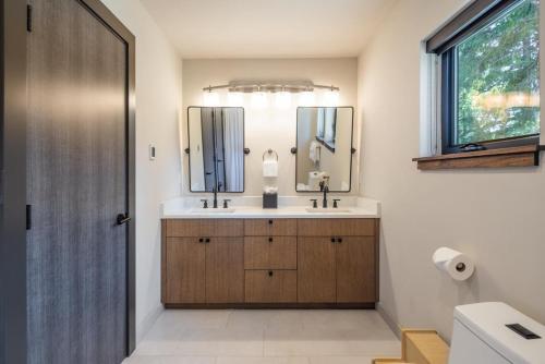 a bathroom with a sink and two mirrors at Suncadia 6 bdrm luxurious with magnificent golf views in Cle Elum