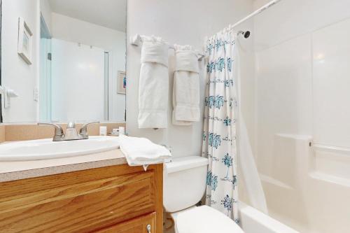 a bathroom with a sink and a toilet and a shower at Marlin Street Tomehome A in South Padre Island