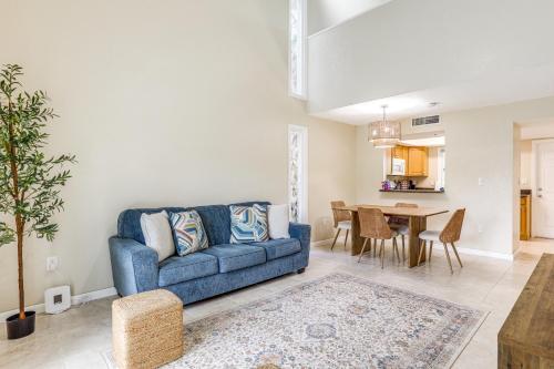 a living room with a blue couch and a table at By Fort Pierce Inlet State Park! Condo with Yard in Fort Pierce