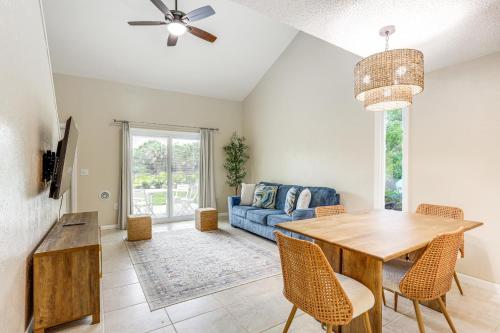 a living room with a table and a blue couch at By Fort Pierce Inlet State Park! Condo with Yard in Fort Pierce