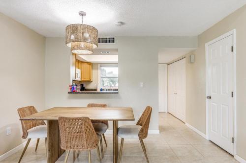 a dining room with a wooden table and chairs at By Fort Pierce Inlet State Park! Condo with Yard in Fort Pierce
