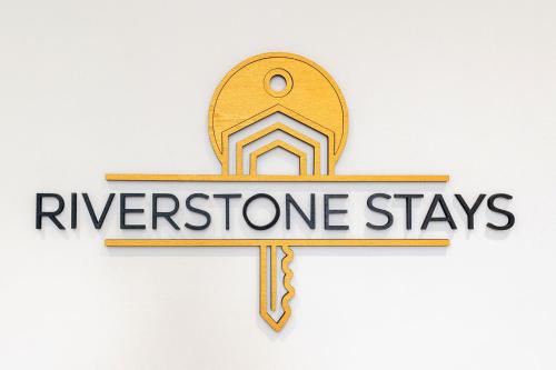 a wooden cross with a sign that reads riverstone stays at Exceptional Apartment & Gorgeous Interior & King size bed in Leeds
