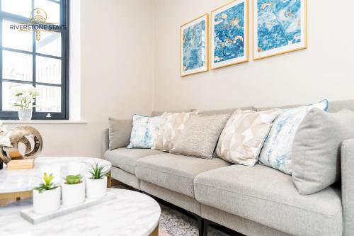 a living room with a couch and a table at Exceptional Apartment & Gorgeous Interior & King size bed in Leeds