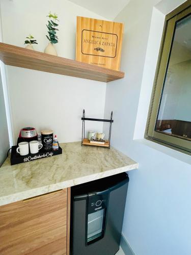 a kitchen with a counter top and a microwave at New Studios by VLV Stays in Salvador