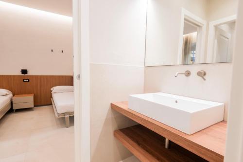 a white bathroom with a sink and a mirror at Affittacamere Saint Bon 15 - 5 Terre Rooms and Suites in La Spezia