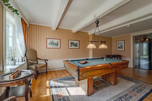 a living room with a pool table in it at Svaneholm Hotel in Svanskog