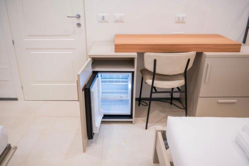 a small kitchen with a desk and a chair at Affittacamere Saint Bon 15 - 5 Terre Rooms and Suites in La Spezia