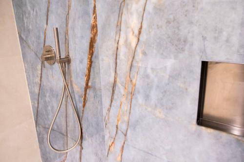 a bathroom with a shower coil on the wall at Affittacamere Saint Bon 15 - 5 Terre Rooms and Suites in La Spezia