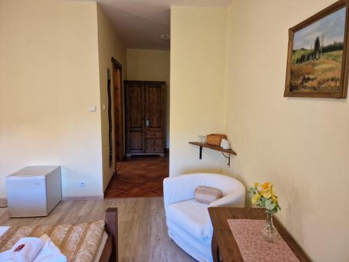 a living room with a couch and a table at Hotel Opat in Kutná Hora
