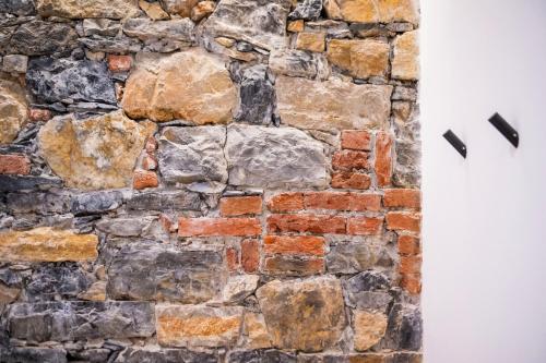 a stone wall with two pieces at Affittacamere Saint Bon 15 - 5 Terre Rooms and Suites in La Spezia