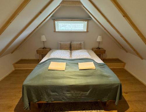 a bedroom with a large bed in a attic at Curry House Apartment in Seyðisfjörður