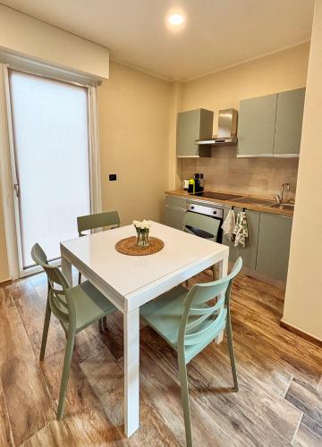 a kitchen with a white table and chairs at Cà Fiorita in Boves