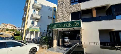 a white car parked in front of a building at Ambassador & Ambassador Lux Apartments in Ulcinj