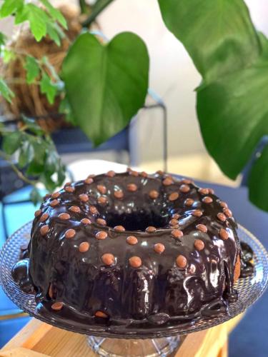 a chocolate cake on a plate on a table at Andardac Hotel in Guaramirim