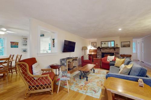 a living room with a couch and a table at Tall Pines in Wellfleet