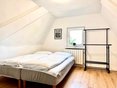a bedroom with a bed in a attic at Familly House in Międzyzdroje