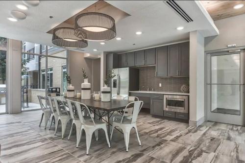 a kitchen and dining room with a table and chairs at Beautiful RiverWalk Apt with Full Amenities, King Bed & Free Parking in San Antonio