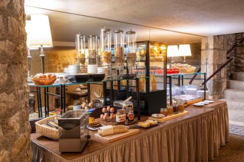 a buffet line with food on display in a restaurant at Best Western de Diane in Nevers